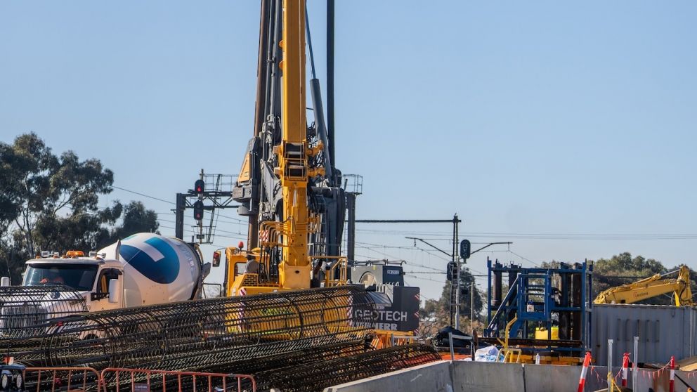 After the piles are drilled, steel cages are lowered into the holes as concrete is poured in