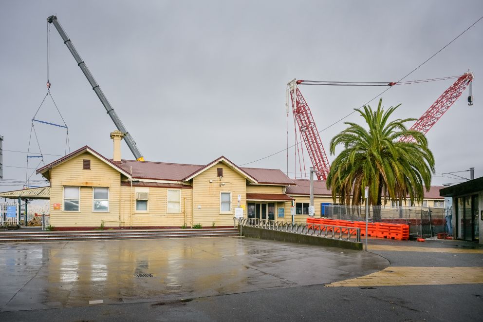 The two cranes that will be lifting the new Mordialloc Station buildings and rail bridge beams into place behind the existing station building