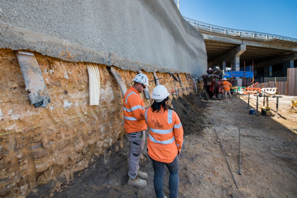 Team members inspect the embankment where we are widening the Klauer Street bridge site for the construction of the spur track at Kananook