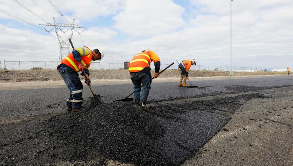 Laying the final coat of asphalt to build the new entry and exit ramps from O’Herns Road.