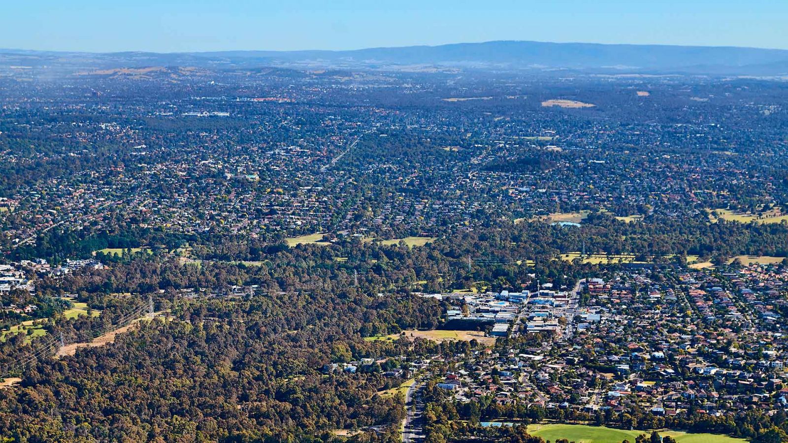 Aerial view of Bulleen Road surrounded by buildings, trees and open space.