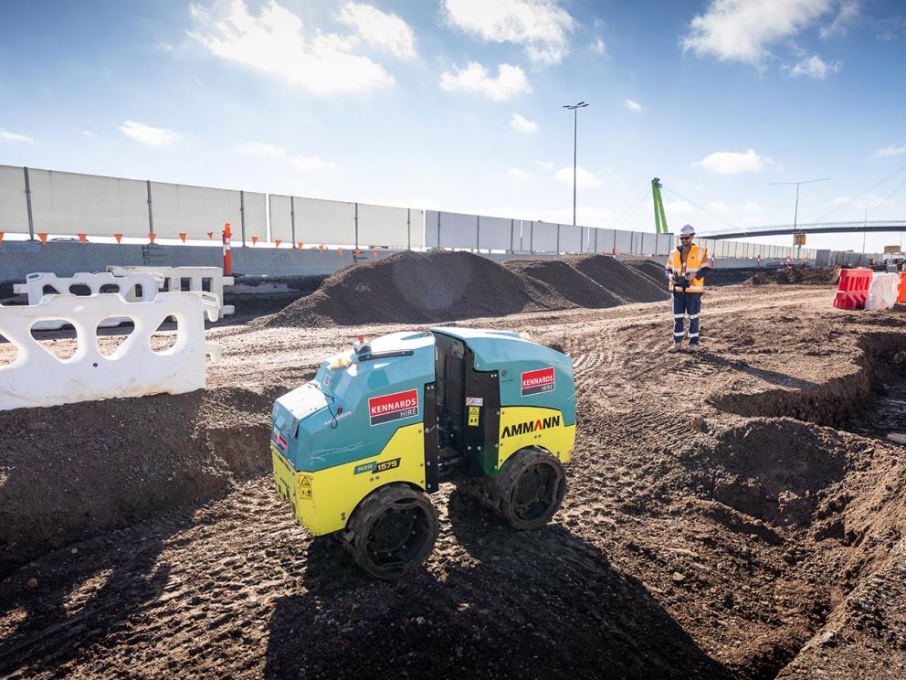 Remote controlled trench roller compacting soil