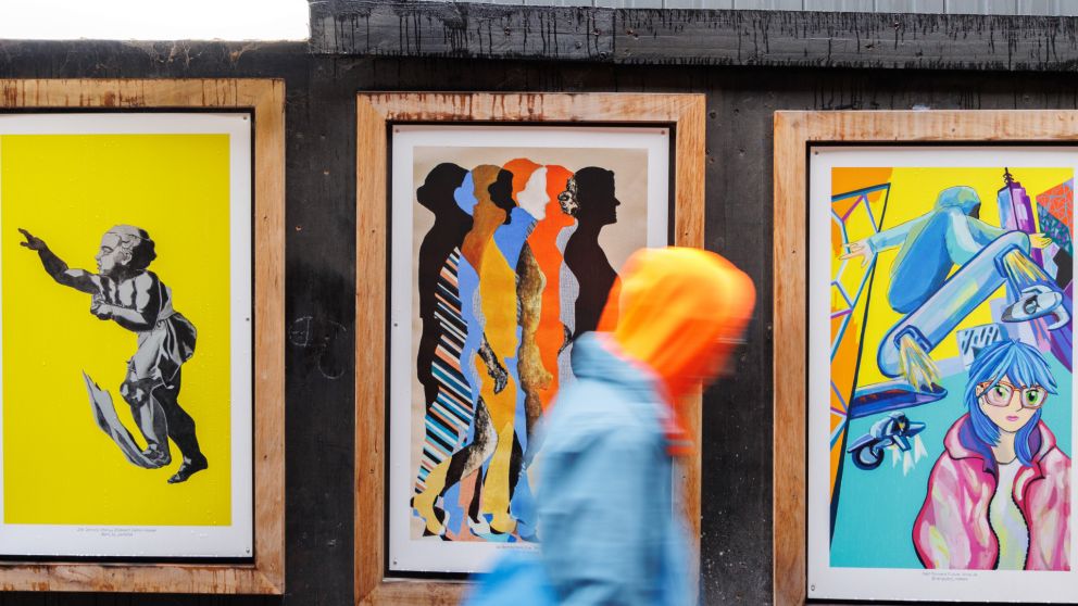 View of colourful artworks in frames along the hoardings on Franklin Street