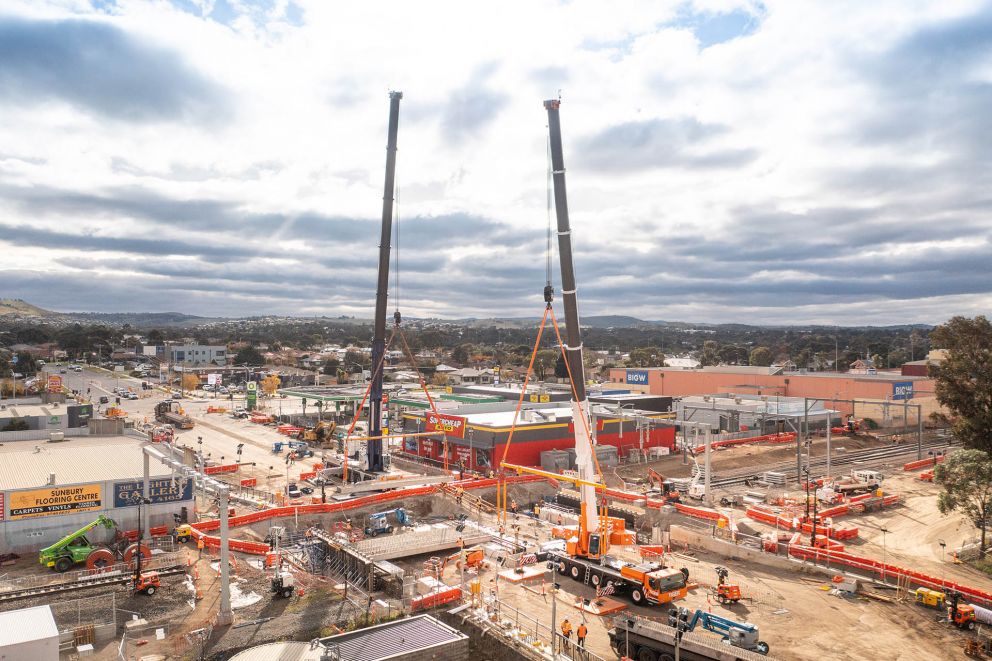 Aerial view of 2 cranes towering over a large construction site at Gap Road