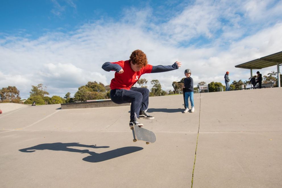 A young boy practicing on a skate ramp.