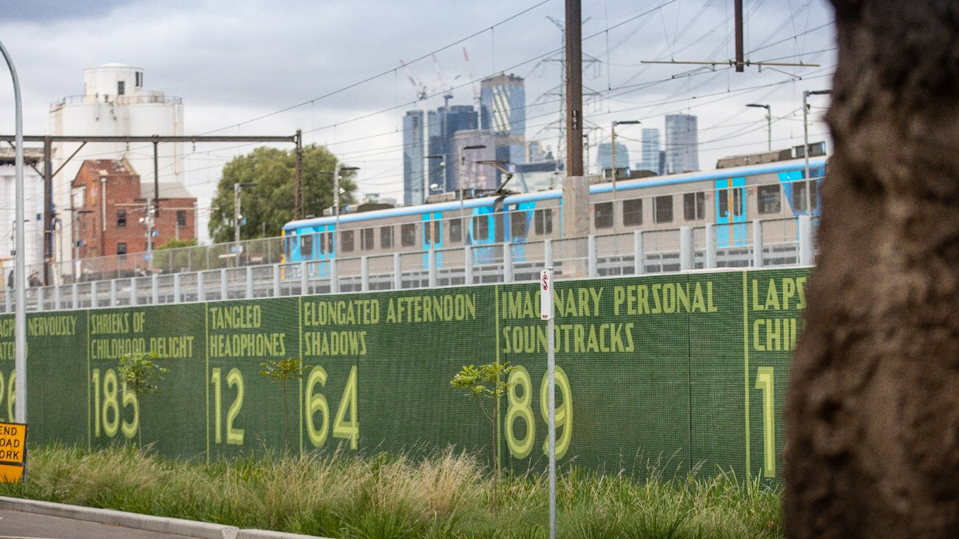 The Kensington flood wall with a green back ground and yellow numbers visible on it