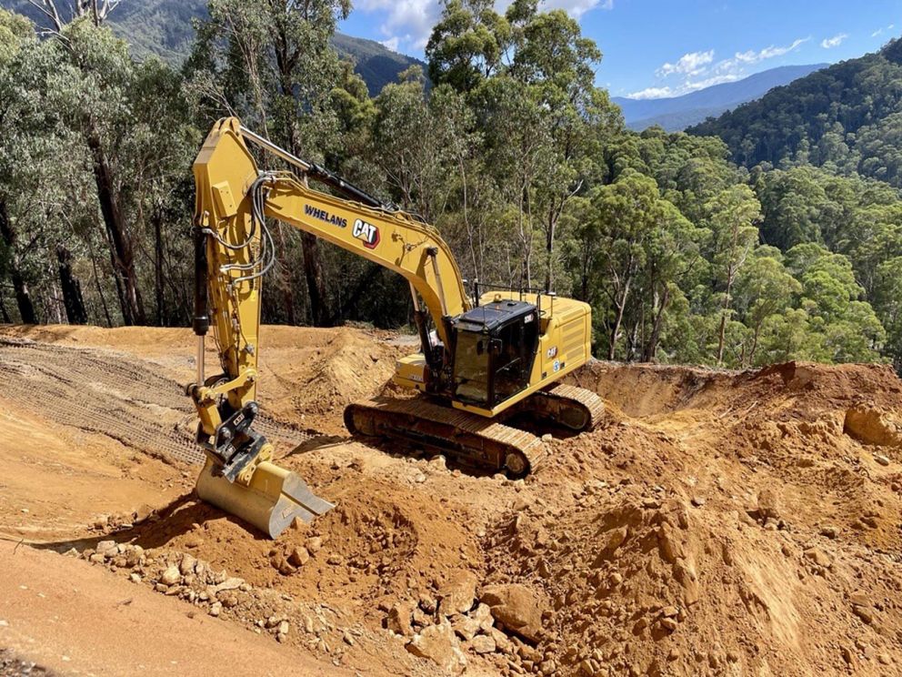 An excavator shapes the slope face and collects material on top of the landslip 7 March