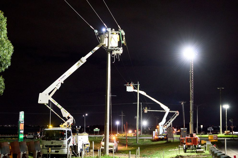 The nightworks team stationed high and low to restring powerlines at Western Port Highway at Hall Road