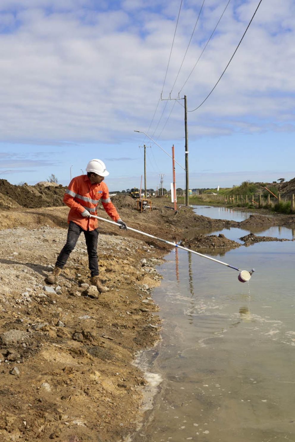 Our trusty environmental expert treating a high turbidity swale with coagulant