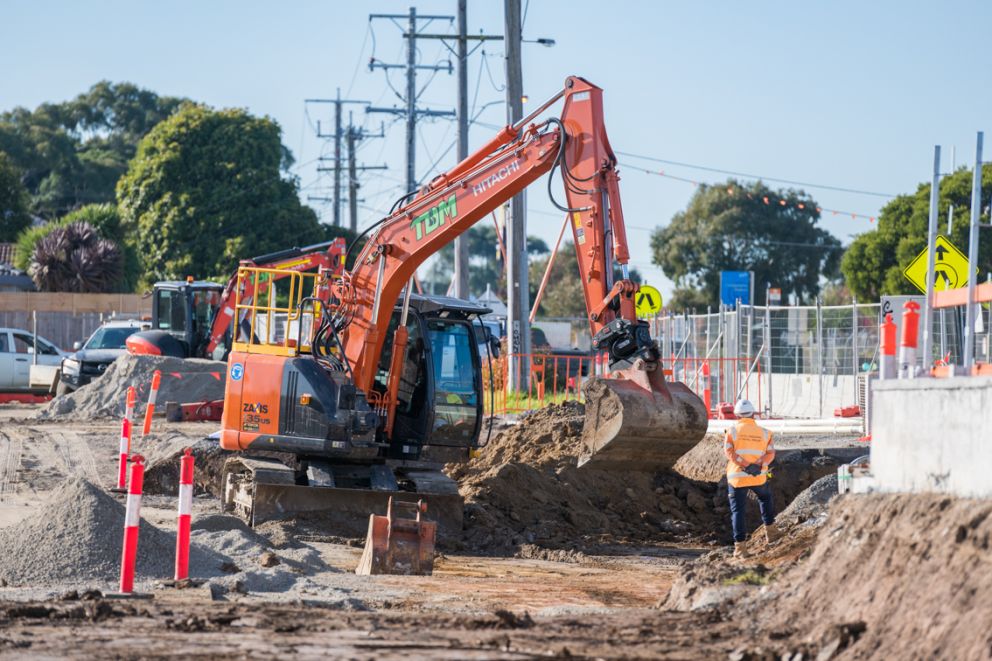 Excavator prepares the site for the new road bridge