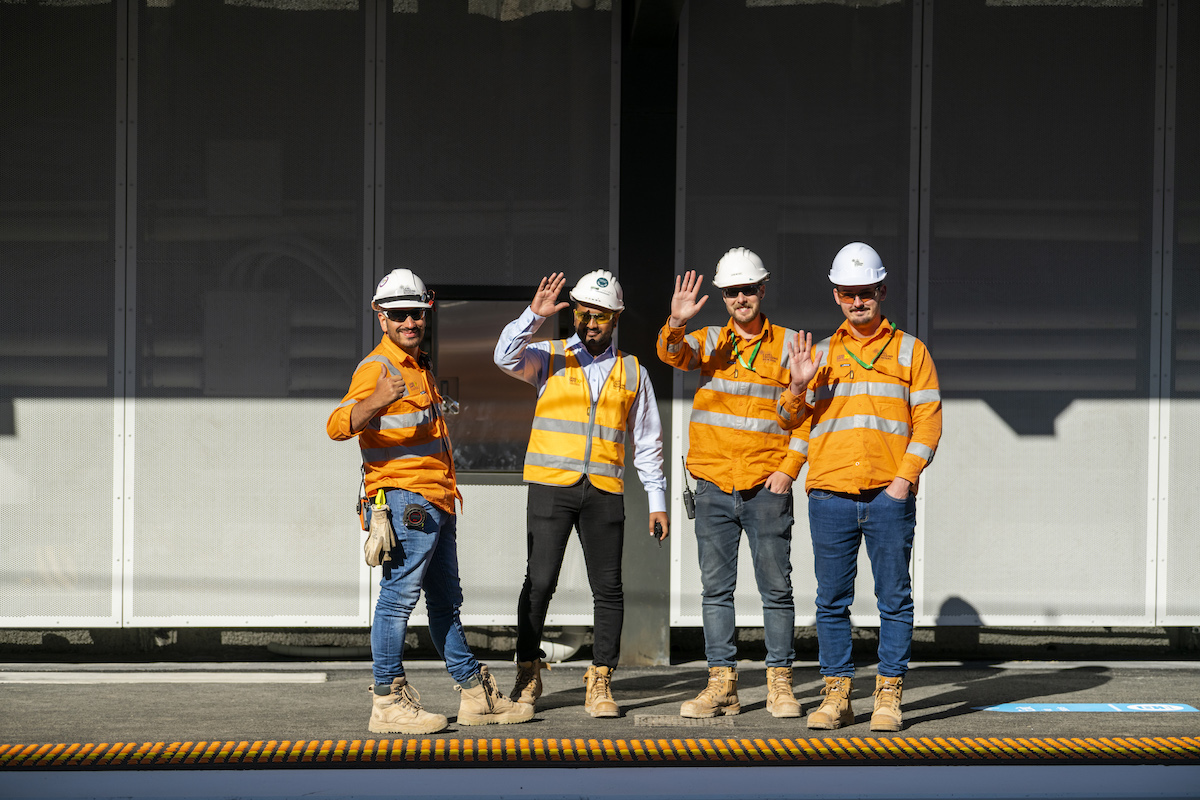 Level Crossing Removal Project crew waving from a train platform