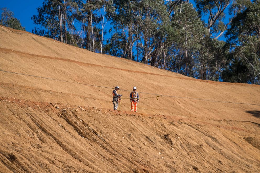 Crews inspect coir mesh on the face of the Bogong High Plains Road Landslip 