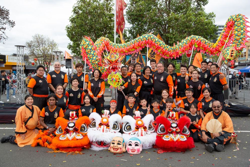Dragon and lion dancing group smiling in a team photo