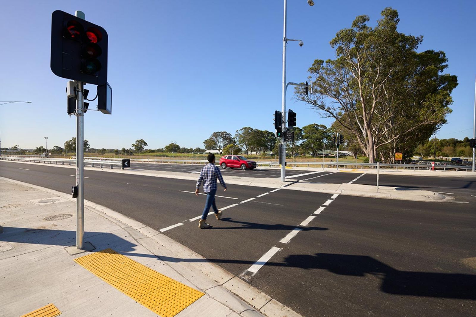 A man walking across the road at an intersection