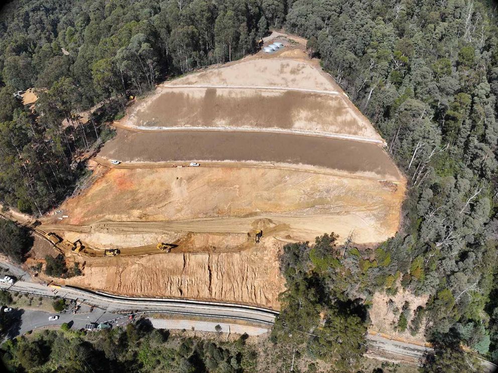Aerial view towards the landslip showing machines clearing at the base near Bogong High Plains Road