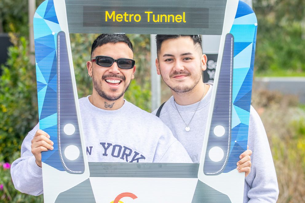 Two men having their photo taken inside a cutout train