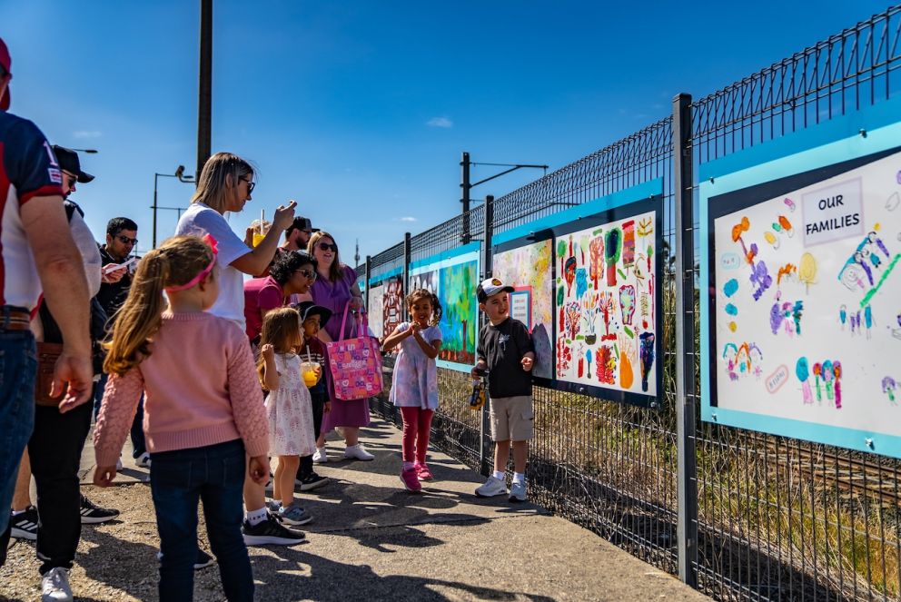 Kids and adults admiring the new artwork at Beaconsfield Station