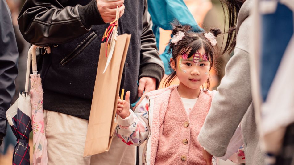 A child attending a SRLA event with her face painted like a unicorn.