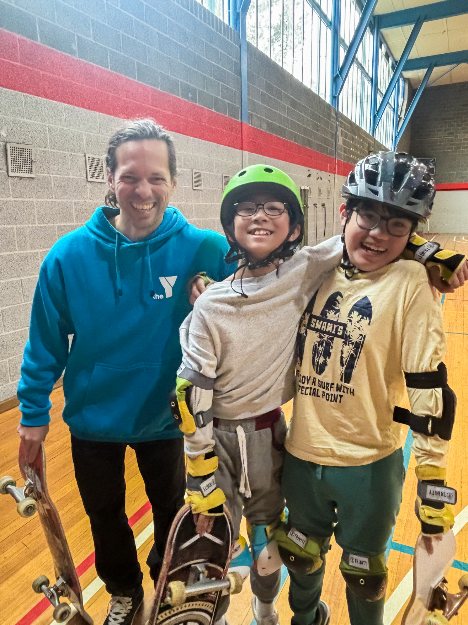 NECF_Instructor With 2 Boys_YMCA Pop Up Skateboard Session