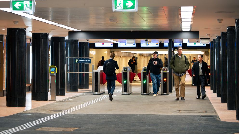 Passengers walk through Campbell Arcade into Flinders Street Station. 
