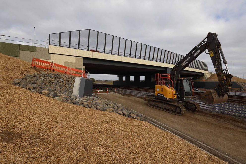 April 2025 - Crews building a rail maintenance track under the overpass
