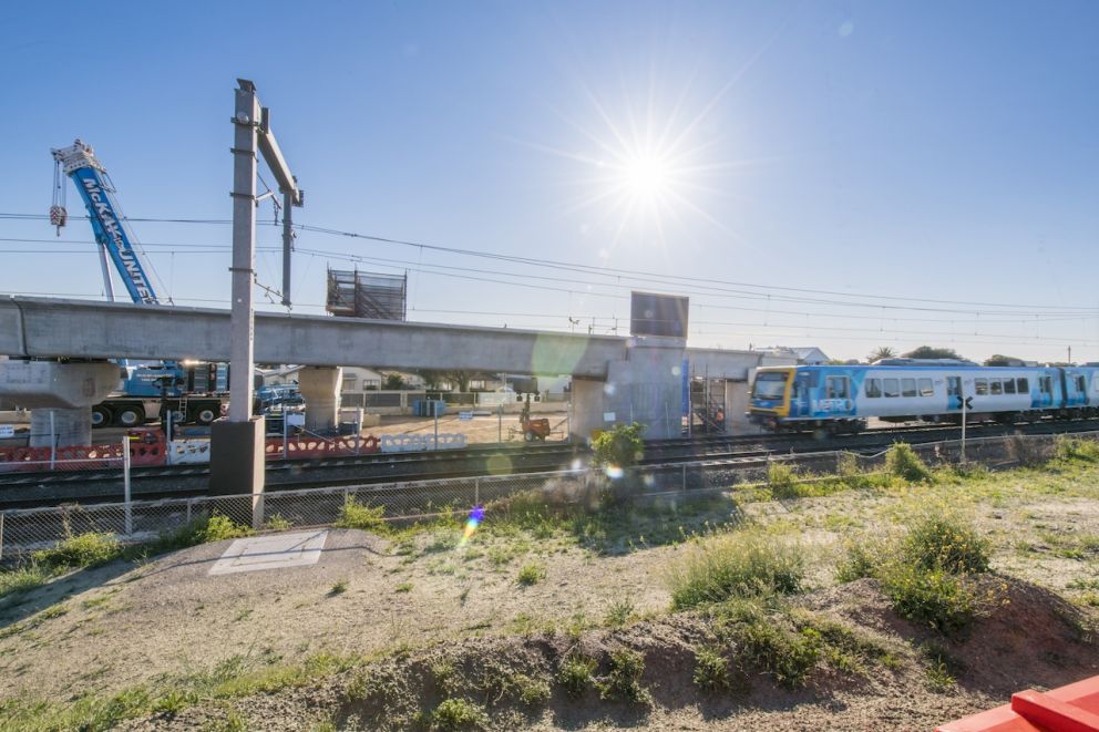 Train running next to Aspendale rail bridge