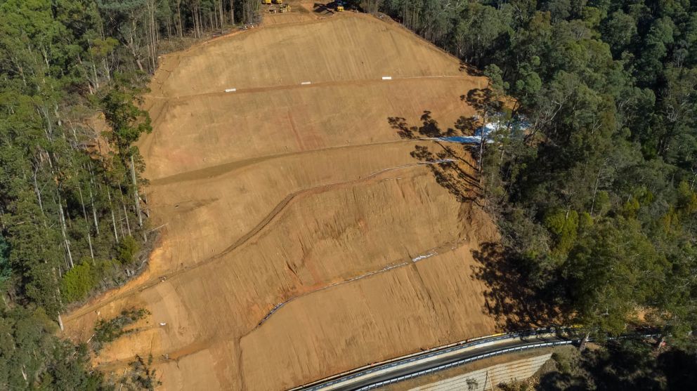 Wide view of the landslip showing benches and construction vehicles