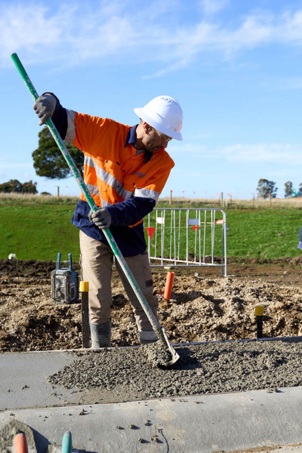 Our expert carefully distributing freshly poured concrete