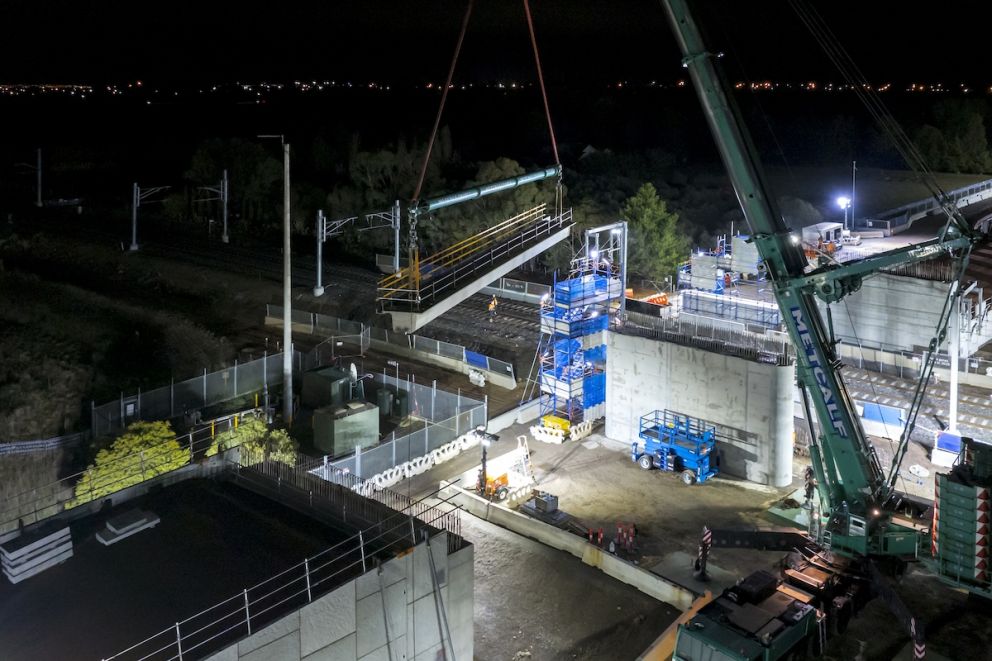 The first of the beams is carefully lifted into place