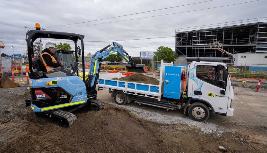 An electric excavator and tip-truck on Pakenham Road Upgrade