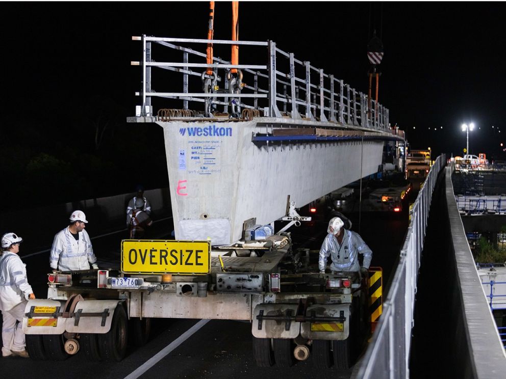 December 2020 Commenced installation of 40 beams at Cardinia Creek. Image of workers assisting the moving of beams on the bridge