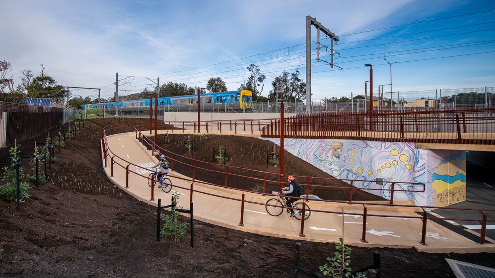 Cyclists travel along the new Frankston line pedestrian path and underpass
