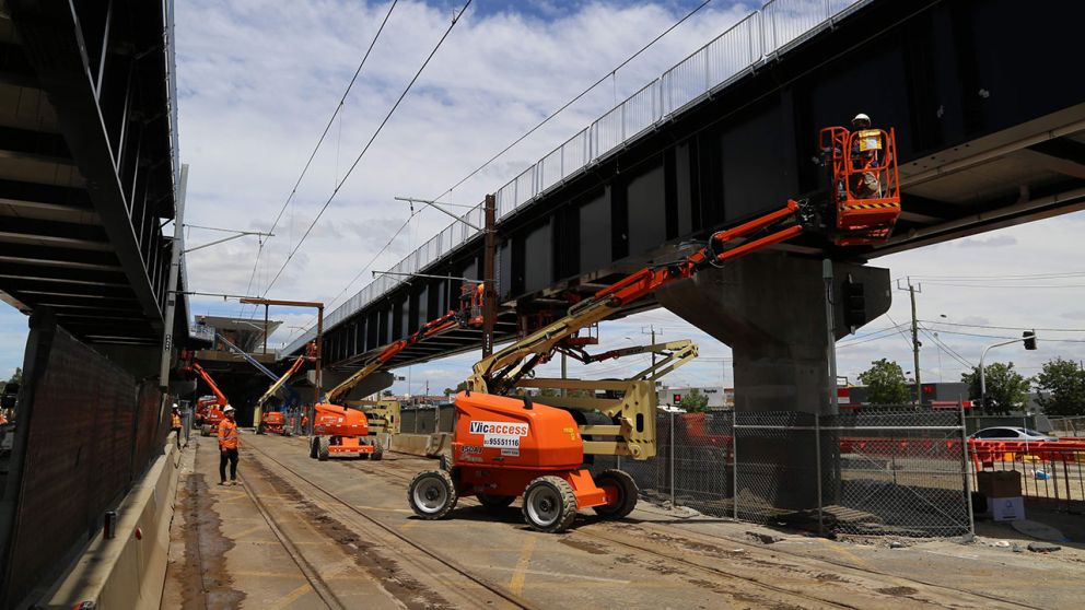 Crews working on the completed rail bridge