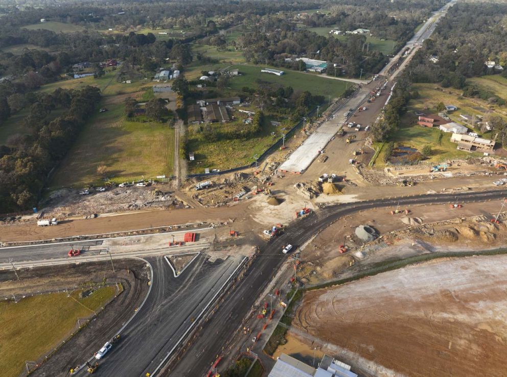 Aerial view of the Cranbourne-Frankston Road intersection looking southbound, with new asphalt east of the intersection 