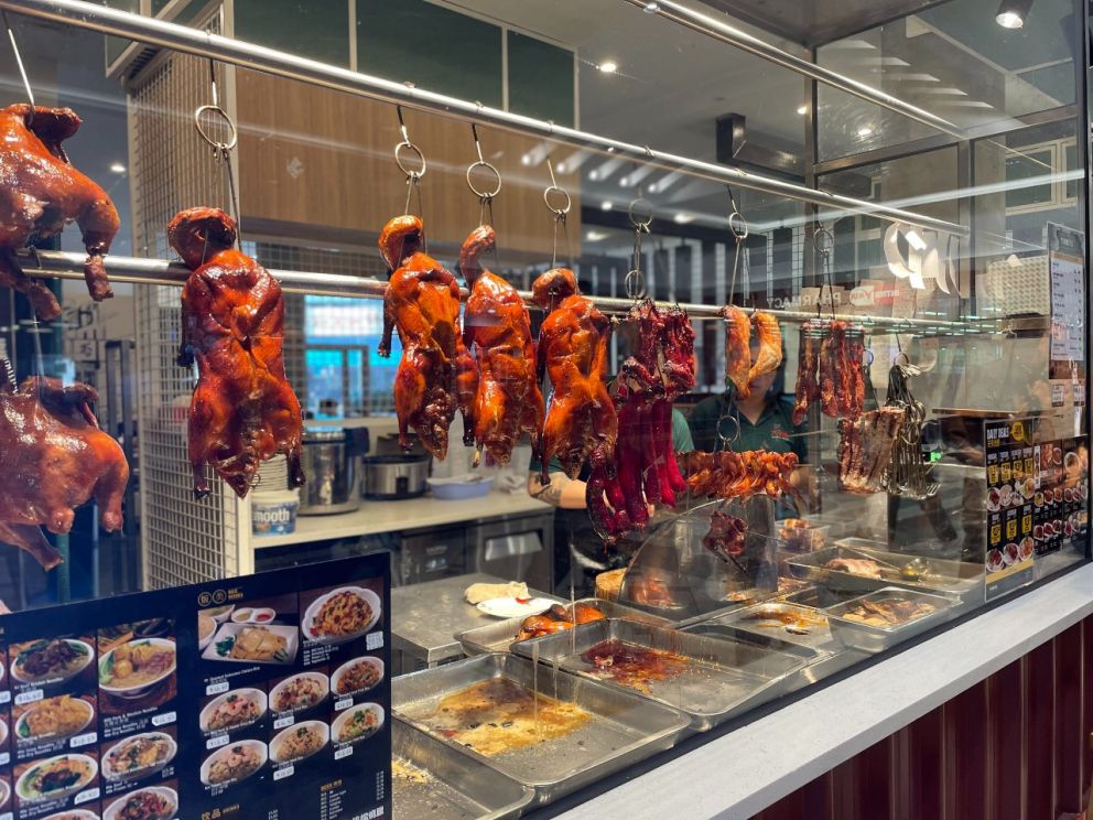 Cooked Peking duck hanging in restaurant window