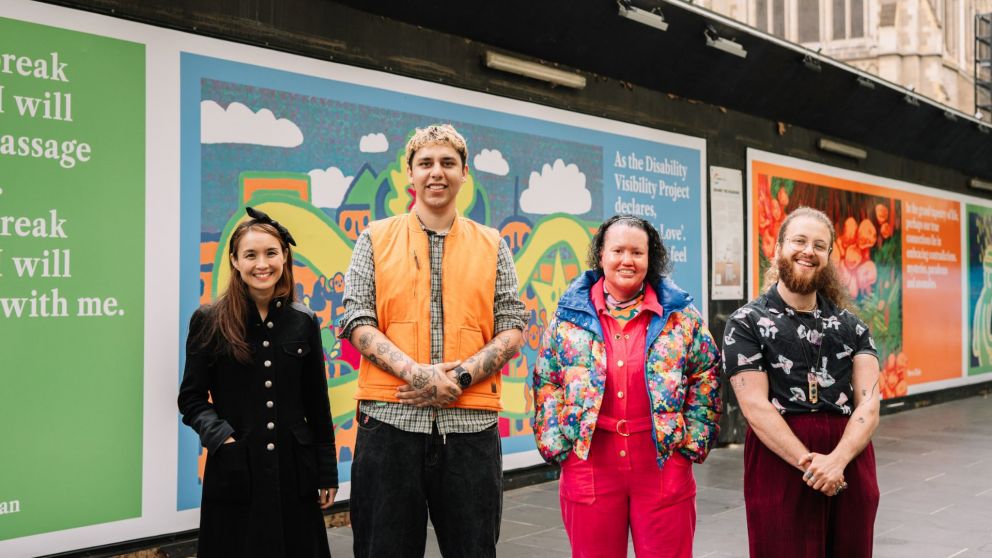 Image of four people standing in front of the Above and Beyond artwork in City Square