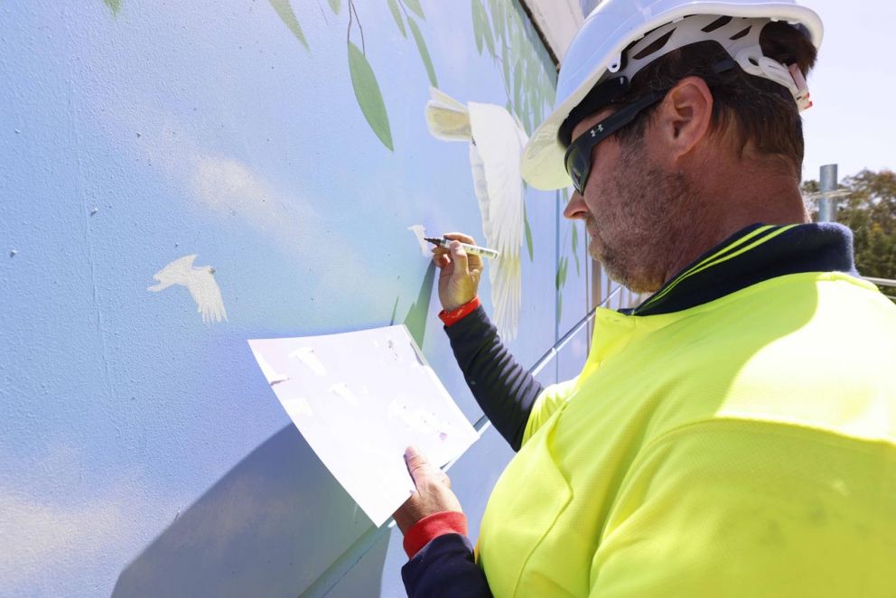 Artist Ervin Molnar at work on the Sunbury Road mural