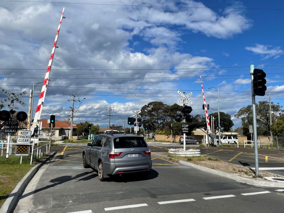 Vehicles crossing the Armstrongs Road level crossing featuring the new, safer traffic lights.
