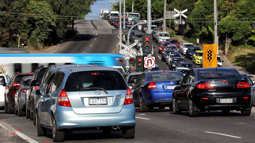 Cars wait at the Toorak Road level crossing before removal works