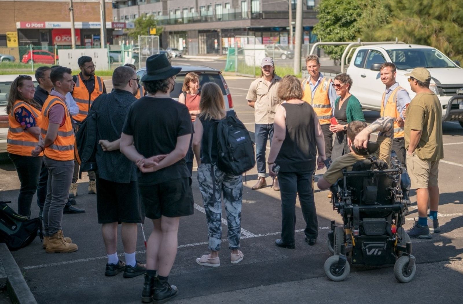 A group of Ability Works participants standing in a circle at Keon Park Station