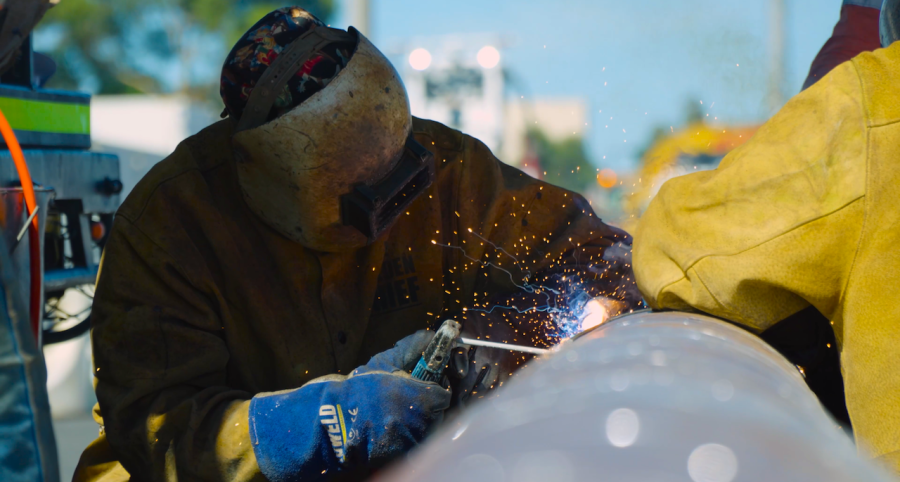Worker welding on the new jet fuel pipeline