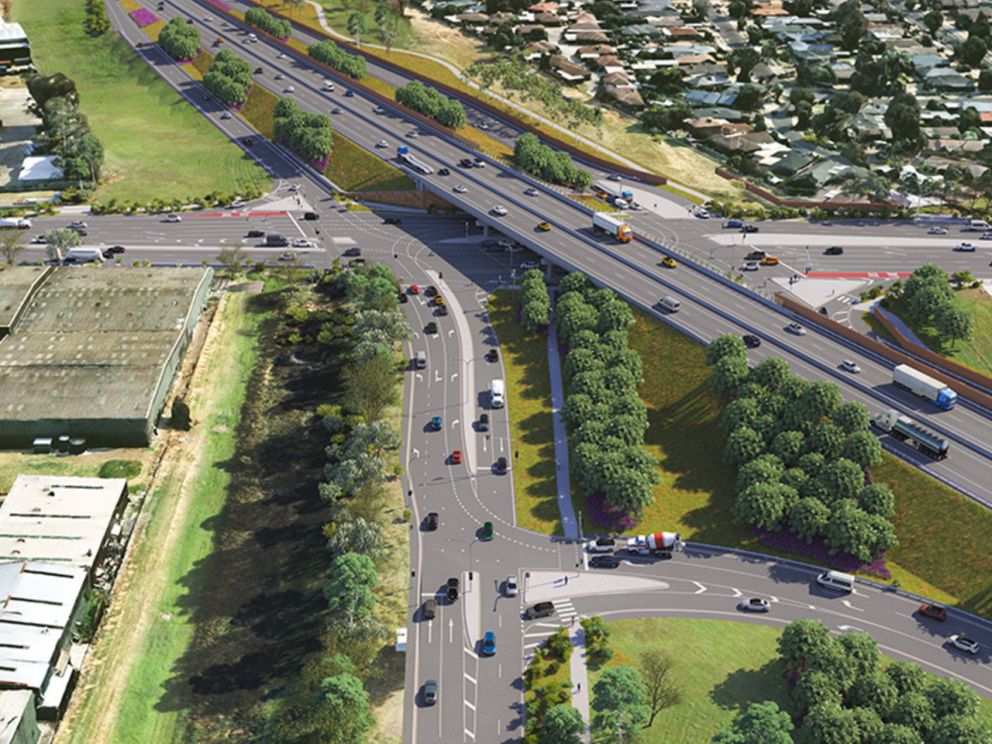 An artist impression of Woodlands Drive from a birds eye view. To the left of the main road there's a series of warehouses etc, whereas to the right there's housing.