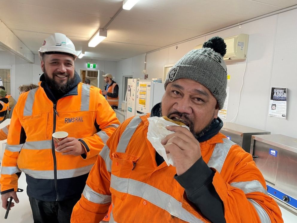 Workers Jeff and Frank enjoy their pies on site