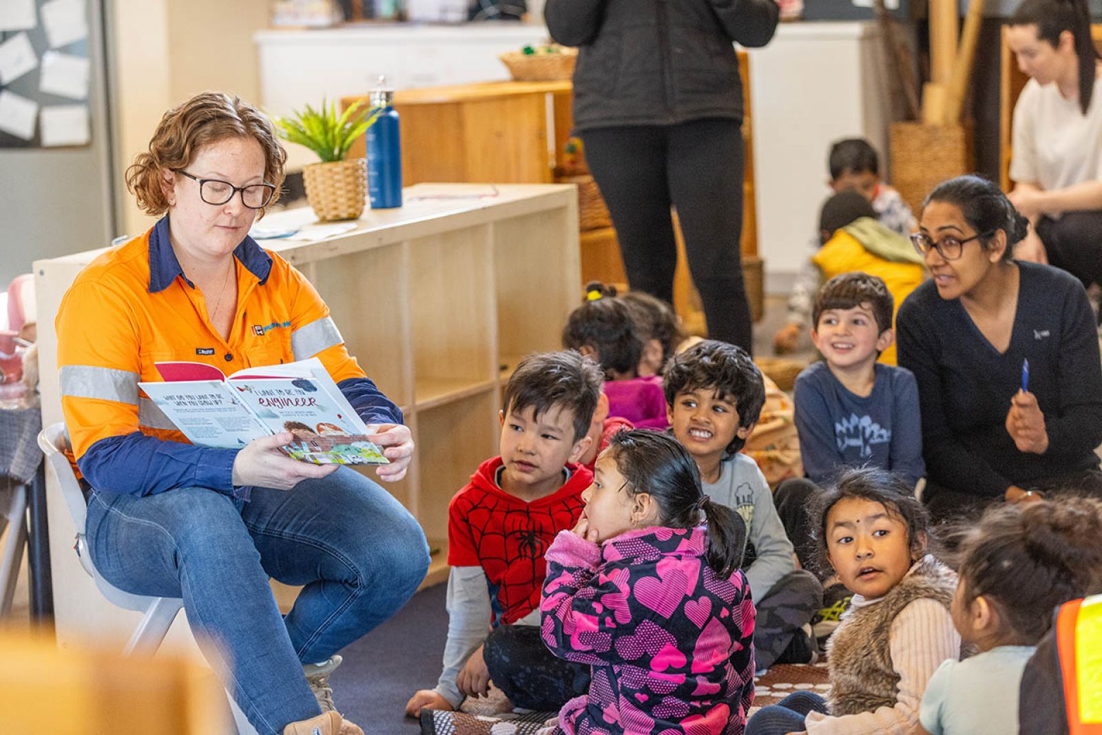 Woman reading to children