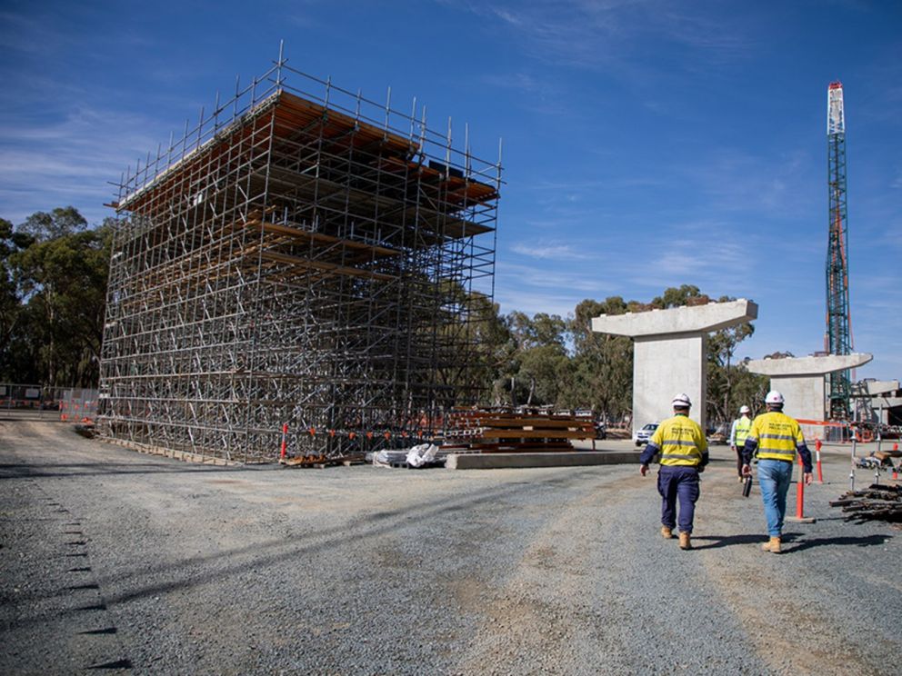 Image of piers on site with construction workers and work within the image