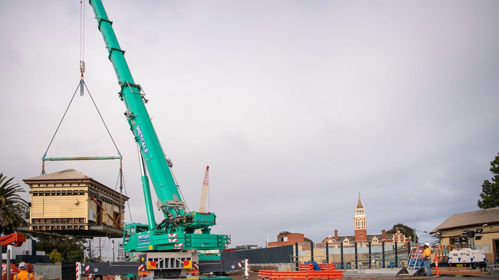 A crane lifts the Mentone Station heritage building