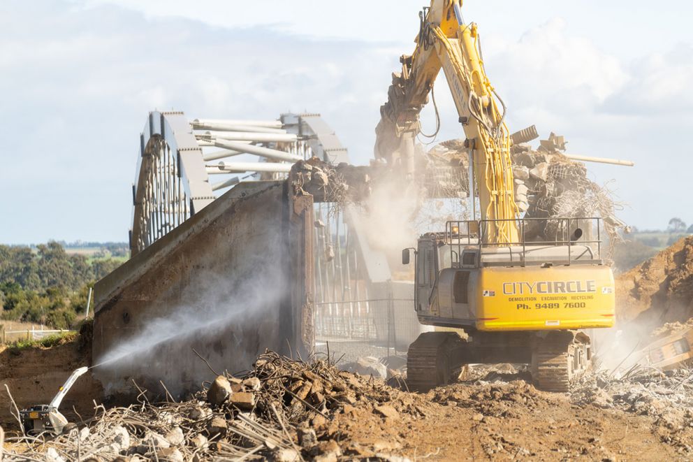 Excavator demolishing the old rail underpass