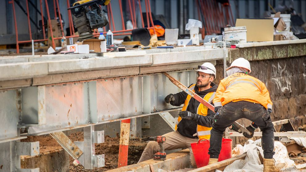 Workers working on an outdoor rail line