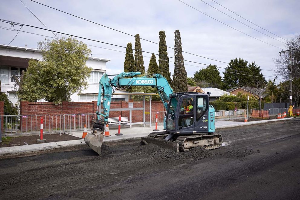 Excavator digging up the top layer of South Road at Tucker Road in preparation for a new layer of asphalt