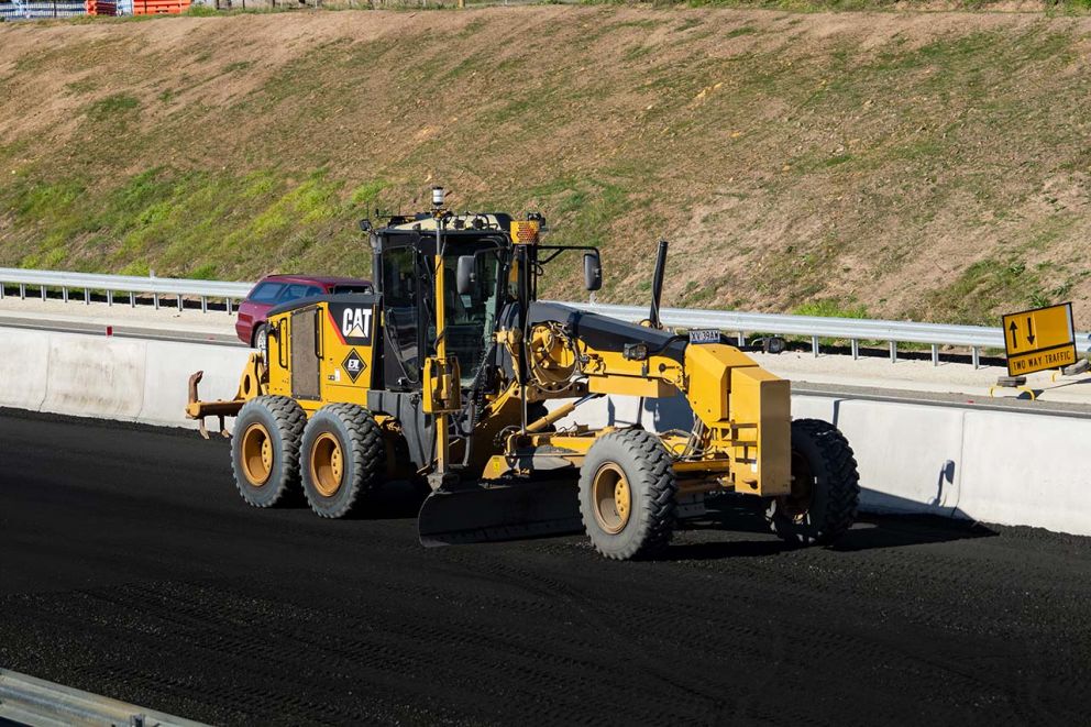 Grader preparing base course for new lanes